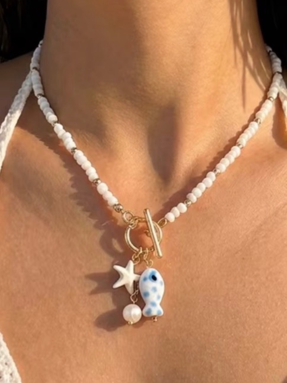 Anthropologie Delicate White Beaded Toggle Necklace with Blue Fish & Star Charms